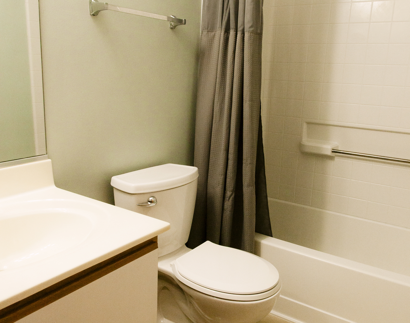 1533 Keystone Court Elgin, IL 60120 - Photo 14 of 16 a white toilet sitting next to a bathroom sink and a shower
