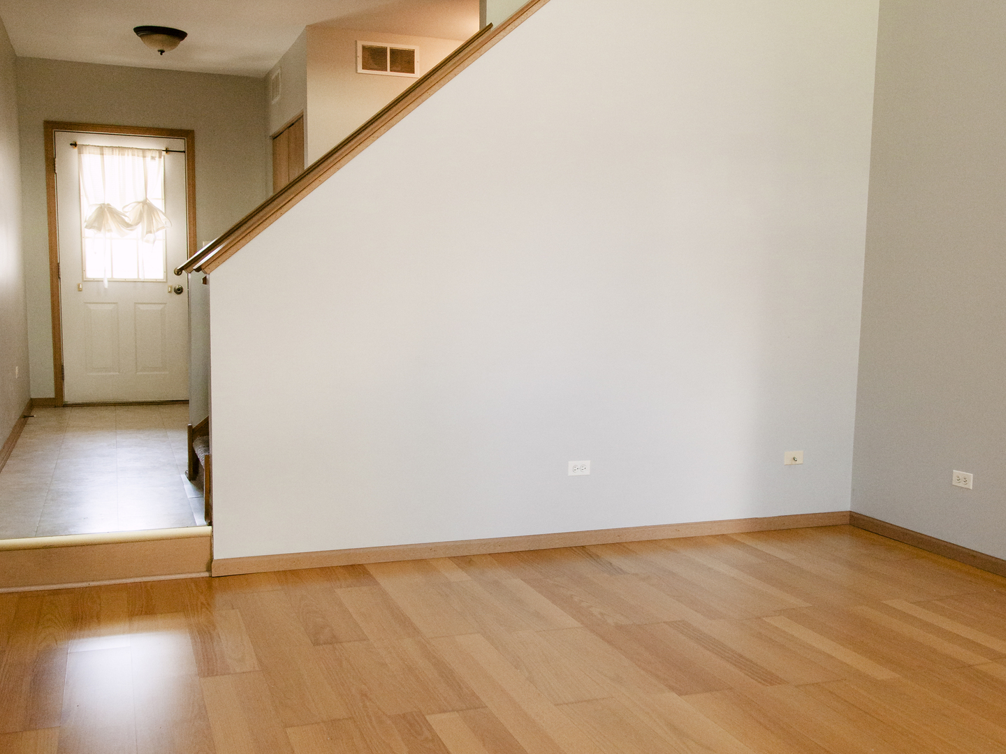 1533 Keystone Court Elgin, IL 60120 - Photo 4 of 16 a view of an empty room with wooden floor and a window