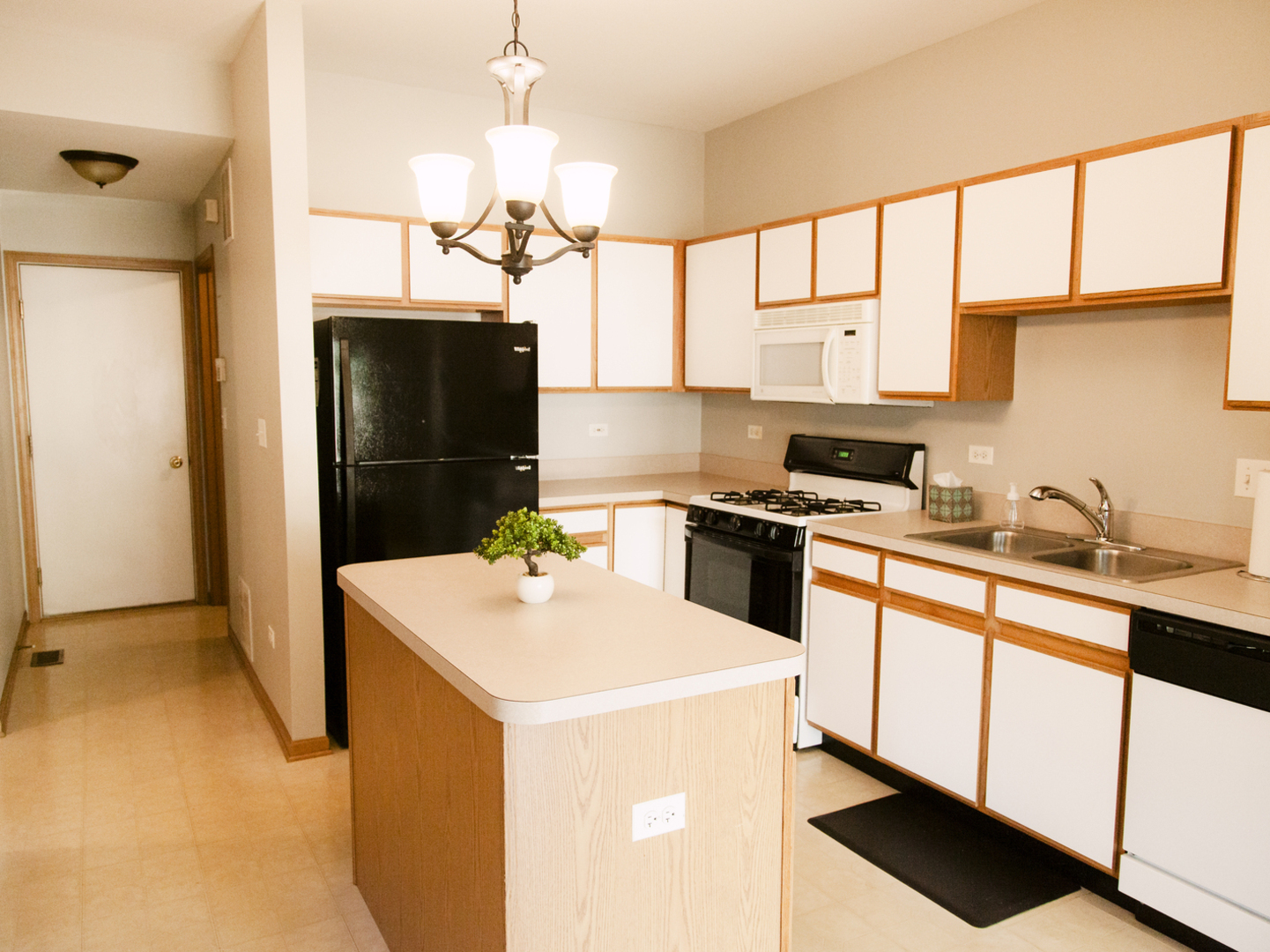1533 Keystone Court Elgin, IL 60120 - Photo 7 of 16 a kitchen with a sink a refrigerator and cabinets