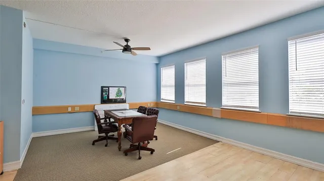a workspace with chandelier and a window