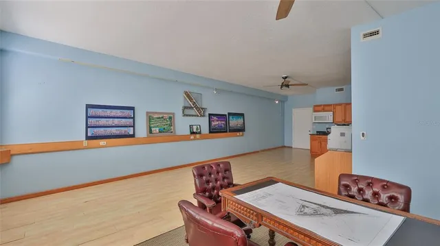a living room with furniture and a bookshelf