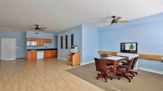 a view of a dining room with furniture and a kitchen