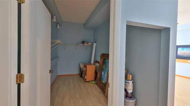 a view of walk in closet with clothes and shoes