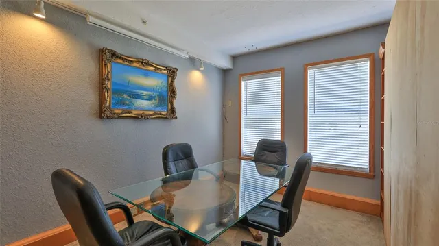 a dining room with furniture and window