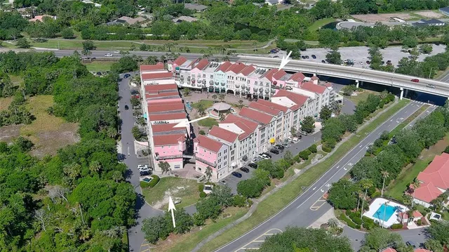 an aerial view of a house with a garden and lake view