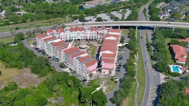 an aerial view of a house with garden space and street view