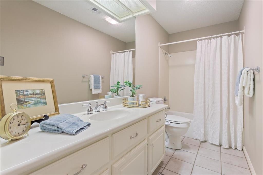 4108 Old Mill Road Waco, TX 76710 - Photo 29 of 39 White vanity with integrated sink, chrome-finish faucet, and substantial storage cabinetry