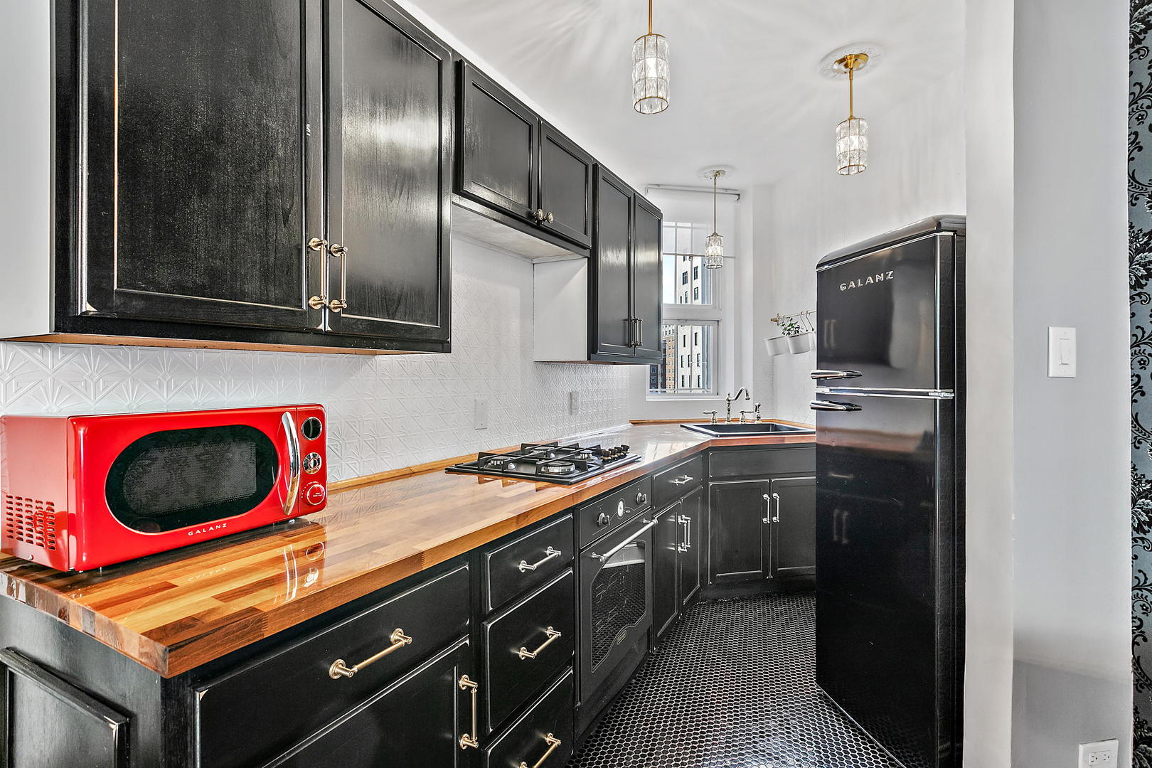 60 East Scott Street, Unit 703 Chicago, IL 60610 - Photo 11 of 27 a kitchen with stainless steel appliances granite countertop a stove a sink and a microwave