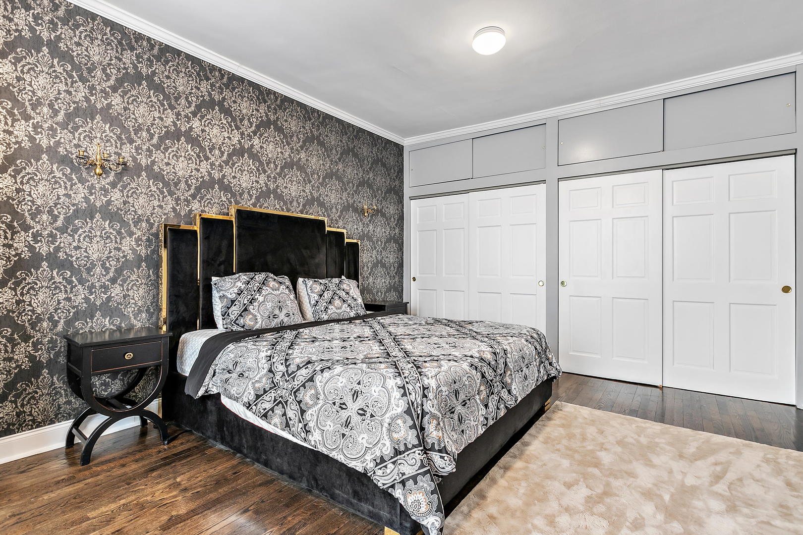 60 East Scott Street, Unit 703 Chicago, IL 60610 - Photo 15 of 27 a bedroom with a bed and wooden floor
