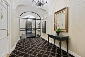 60 East Scott Street, Unit 703 Chicago, IL 60610 - Photo 23 of 27 a view of a hallway with wooden floor and a potted plant