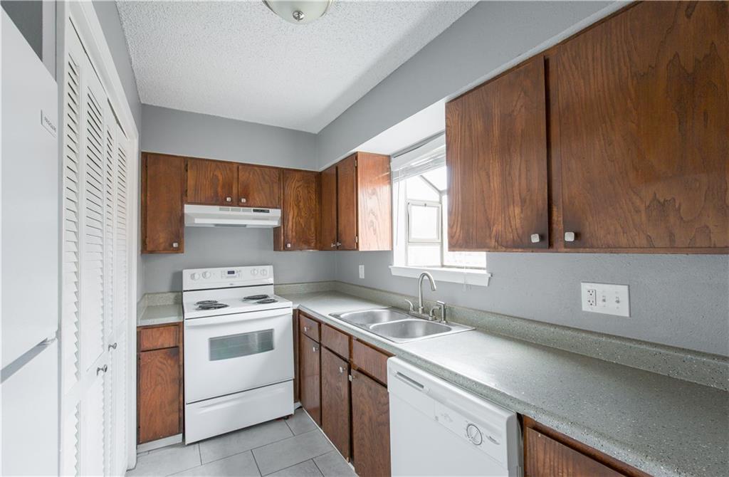 2008 West Loop, Unit D Austin, TX 78758 - Photo 13 of 15 a kitchen that has a sink and a stove