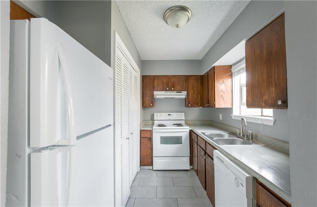 2008 West Loop, Unit D Austin, TX 78758 - Photo 14 of 15 a kitchen with a sink stove and cabinets