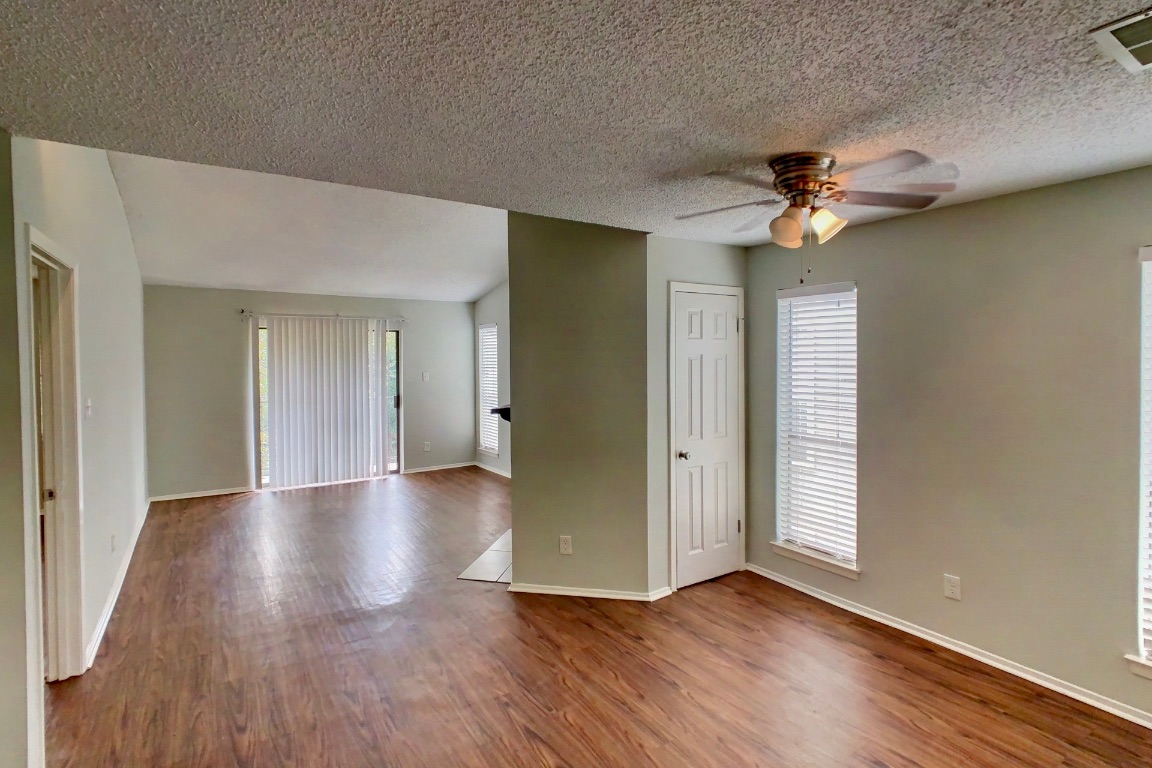 2008 West Loop, Unit D Austin, TX 78758 - Photo 3 of 15 wooden floor in an empty room with a window