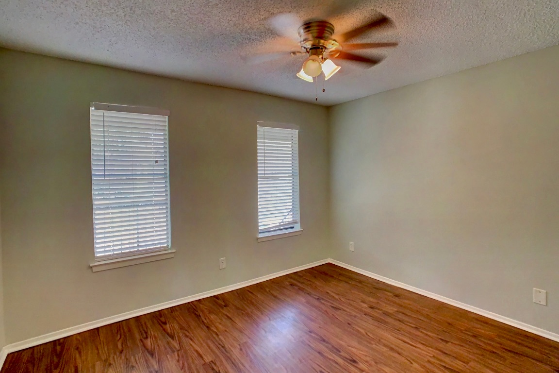 2008 West Loop, Unit D Austin, TX 78758 - Photo 9 of 15 a view of empty room with wooden floor and fan