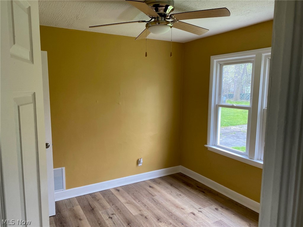 2508 Greenvale Road Cleveland, OH 44121 - Photo 11 of 16 Empty room featuring ceiling fan and light wood-type flooring