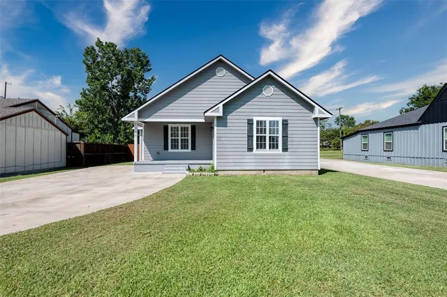 a front view of house with yard and green space