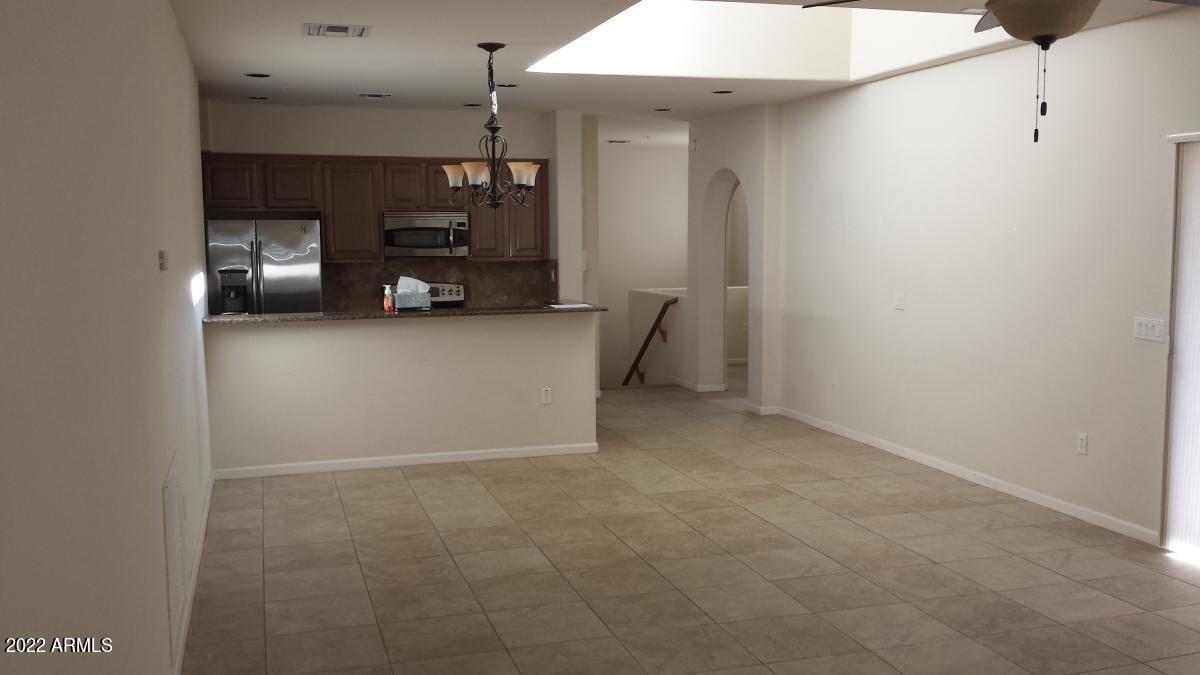3935 East Rough Rider Road, Unit 1074 Phoenix, AZ 85050 - Photo 10 of 22 Living to Kitchen