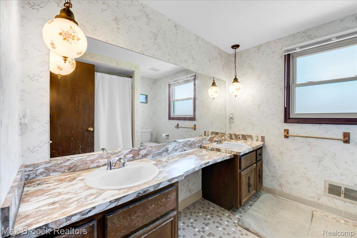 217 Stonetree Circle Rochester, MI 48309 - Photo 32 of 44 Spacious bathroom featuring an extended vanity with dual integrated sinks and a large wall-mounted mirror