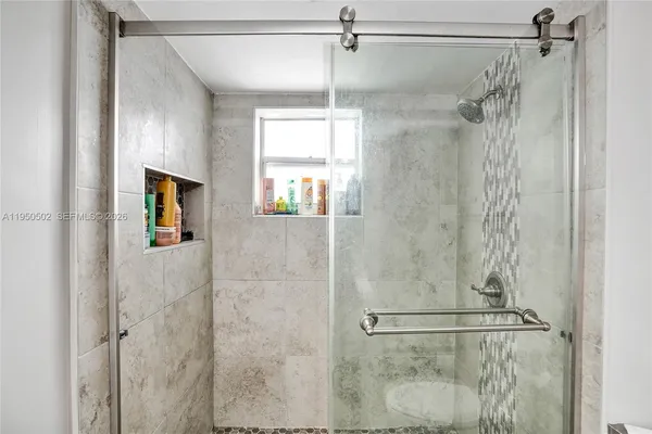 a view of a dining room with furniture and a chandelier