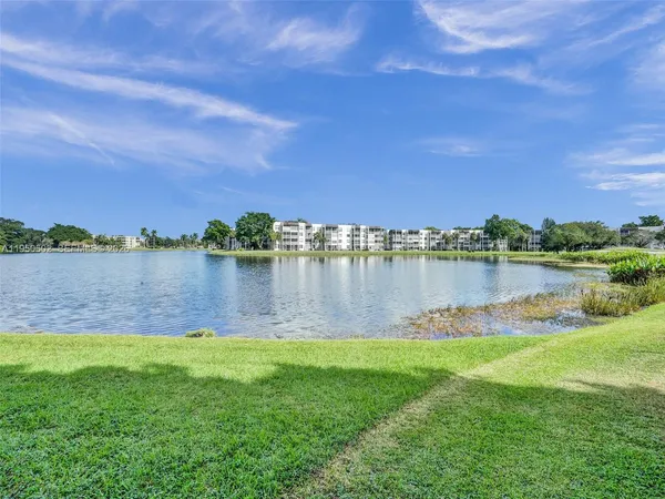 a view of a lake with houses in the background