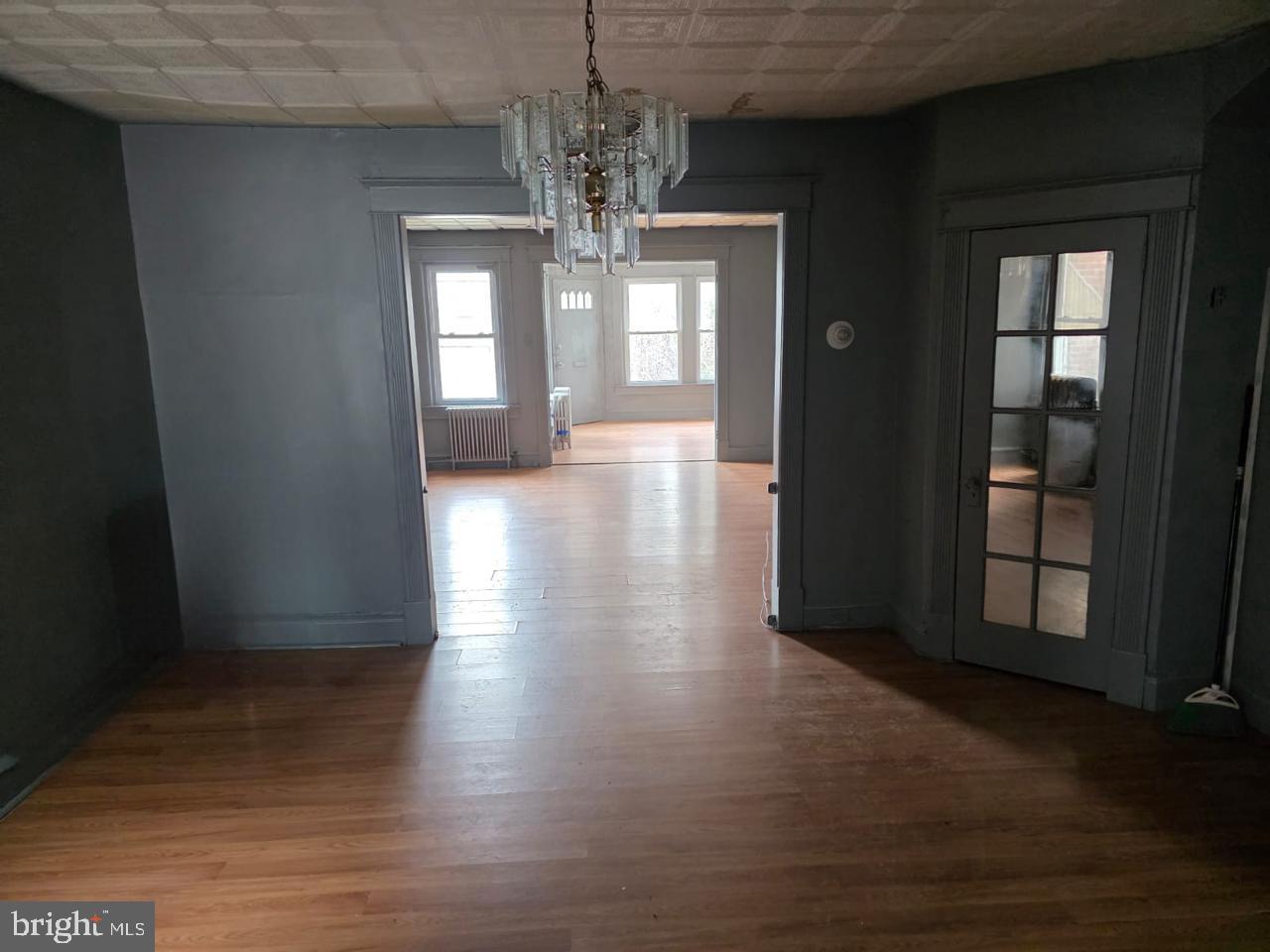 5805 North 15th Street Philadelphia, PA 19141 - Photo 11 of 12 a view of a hallway with wooden floor and chandelier