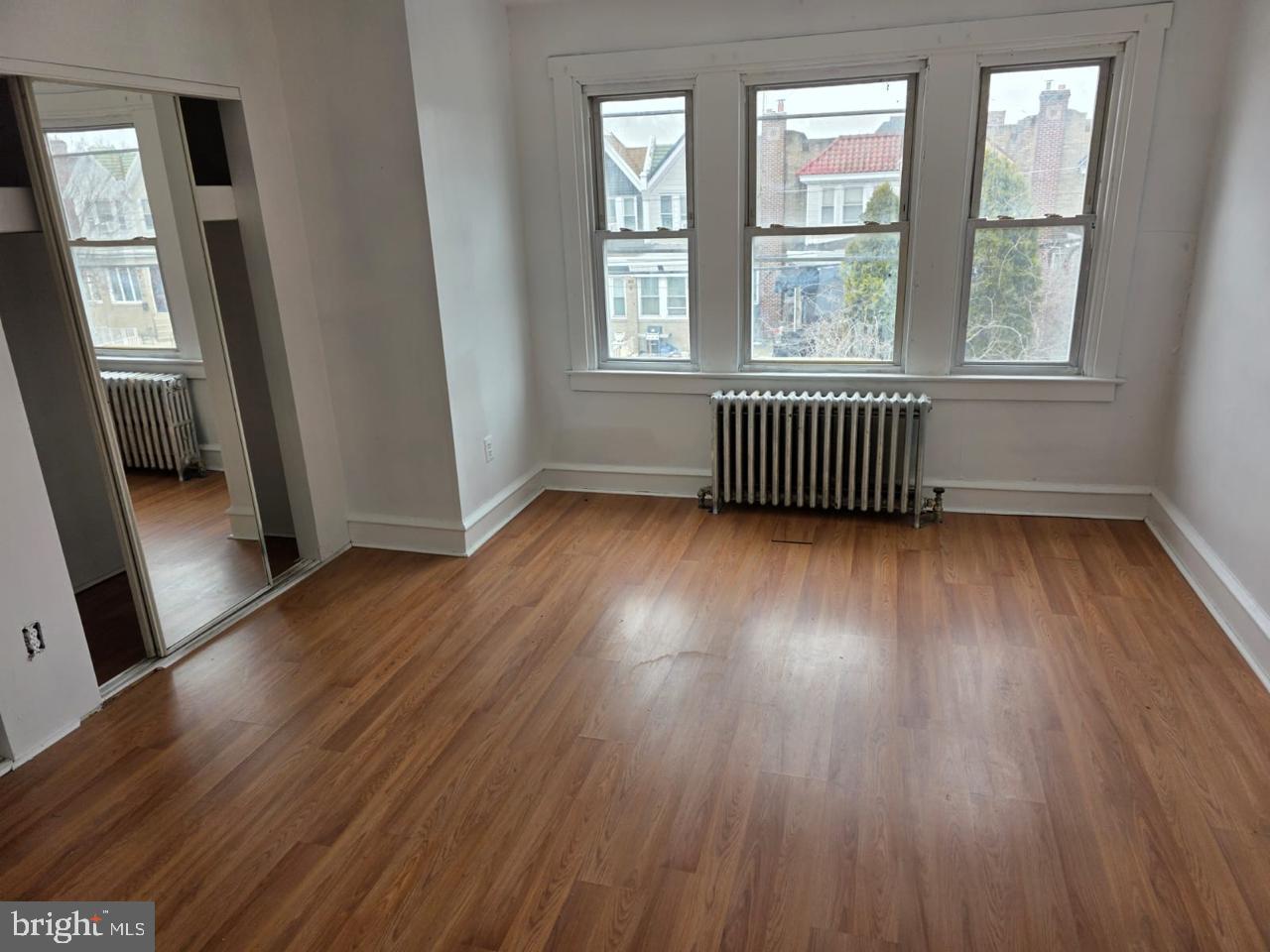 5805 North 15th Street Philadelphia, PA 19141 - Photo 7 of 12 an empty room with wooden floor and windows