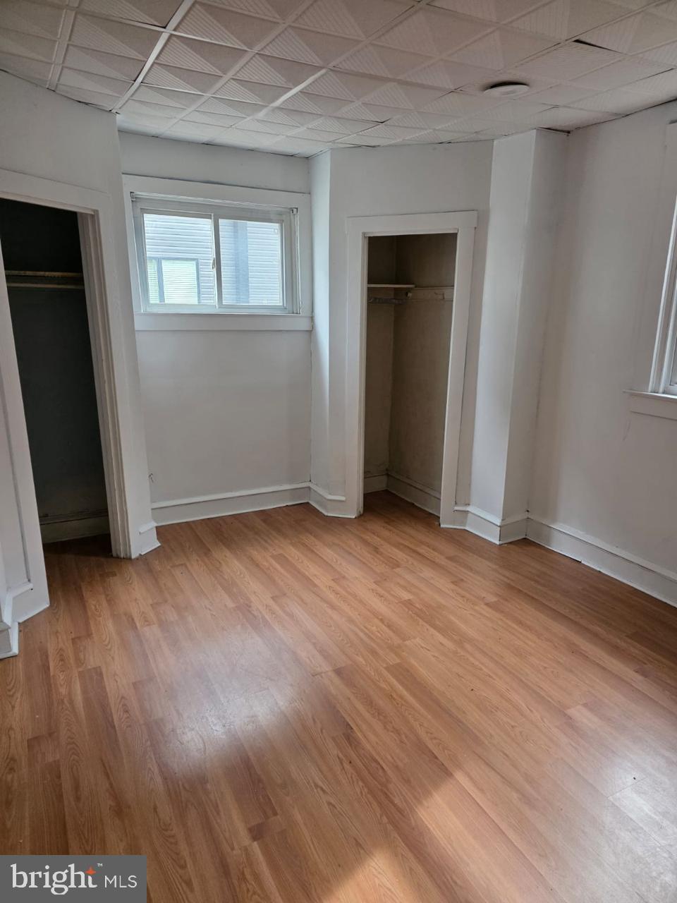 5805 North 15th Street Philadelphia, PA 19141 - Photo 8 of 12 an empty room with wooden floor and windows