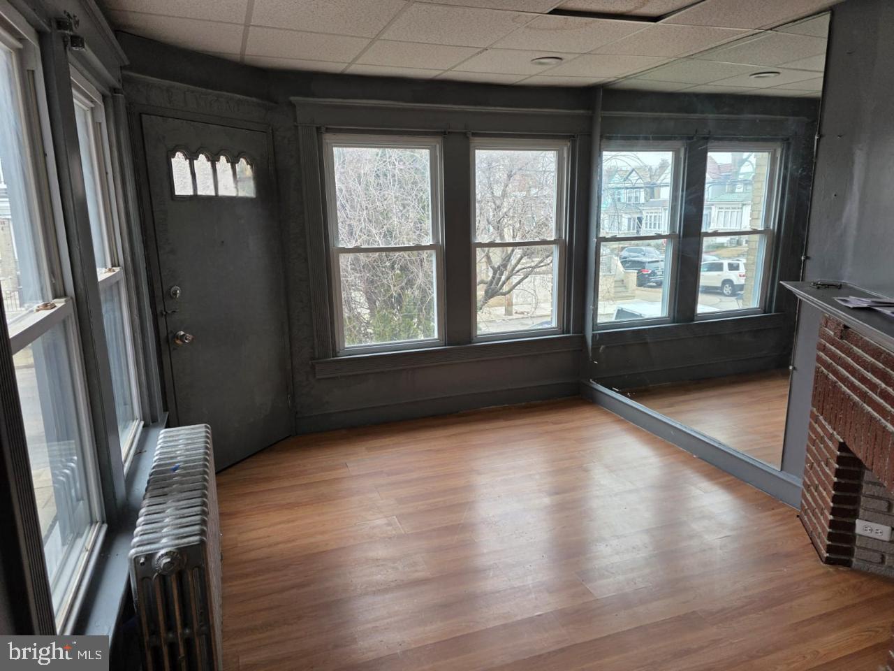 5805 North 15th Street Philadelphia, PA 19141 - Photo 9 of 12 wooden floor in an empty room with a window