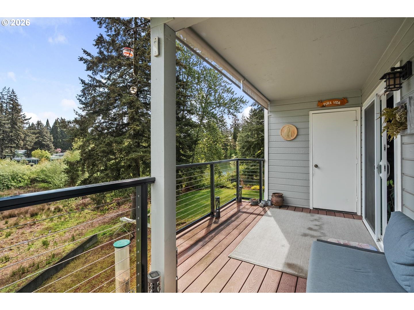 1840 Rees Hill Road Southeast, Unit 19 Salem, OR 97306 - Photo 22 of 34 a view of a balcony with floor to ceiling windows with wooden floor