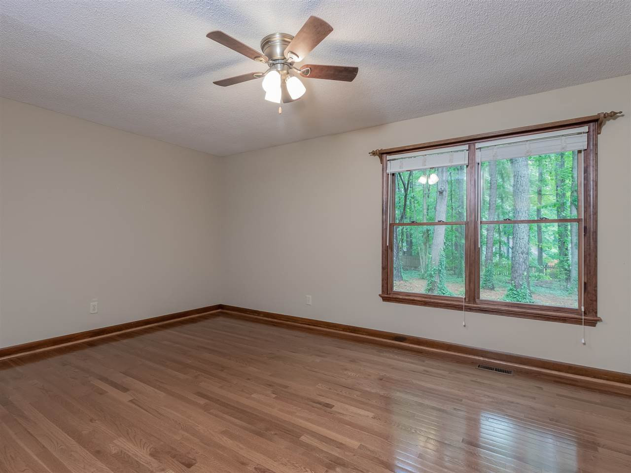 8701 Brandon Station Road Raleigh, NC 27613 - Photo 12 of 30 Your master retreat with hardwood floors overlooking the private backyard. Master Bedroom
