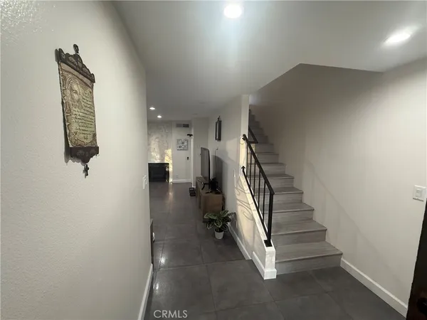 a view of entryway and hall with wooden floor