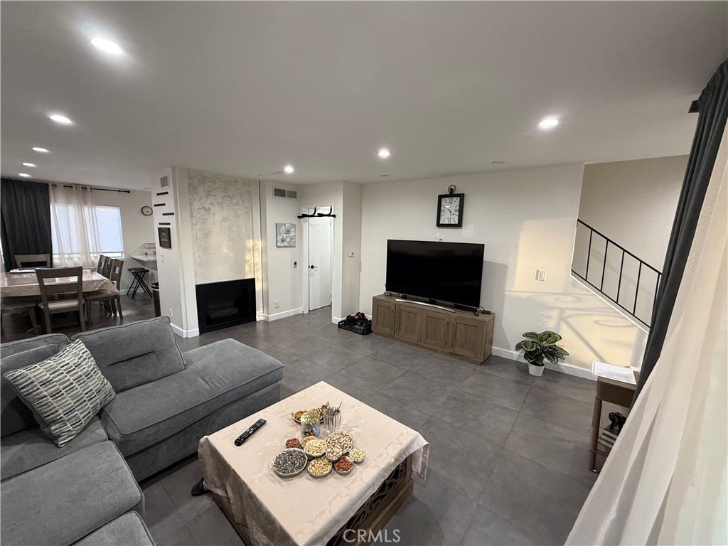 9702 Vía Roma Burbank, CA 91504 - Photo 3 of 19 a living room with furniture and a flat screen tv
