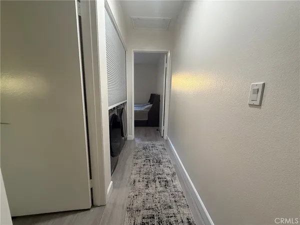 a view of hallway with wooden floor