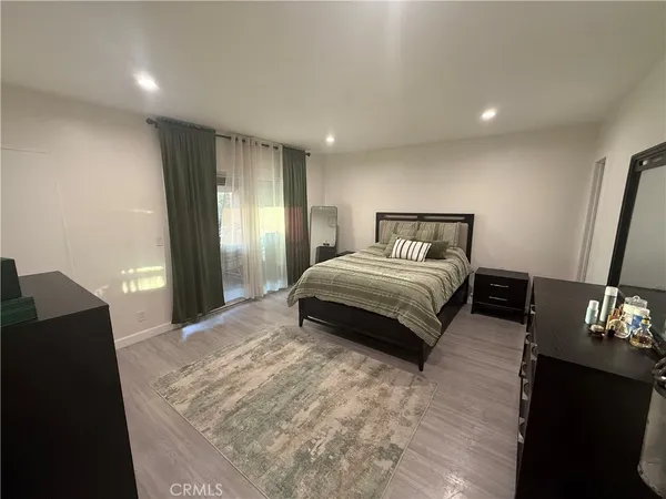 a bedroom with a bed and a dresser