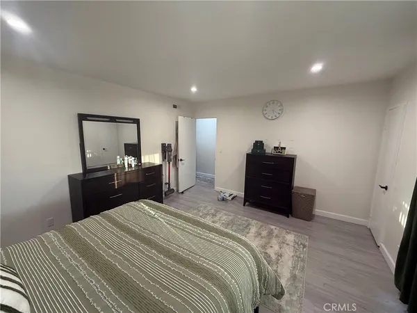 a bedroom with a bed and a dresser