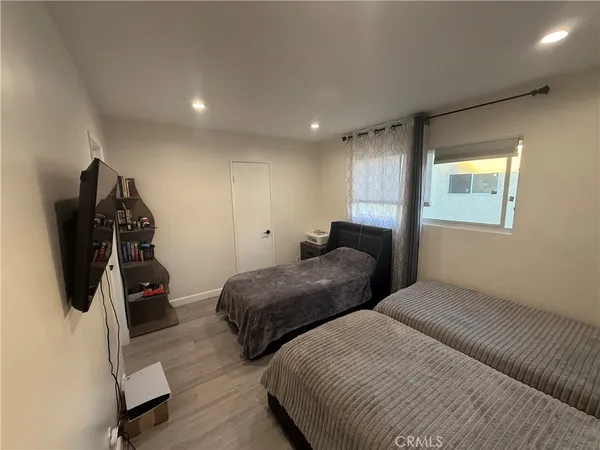 a bedroom with two beds and a window