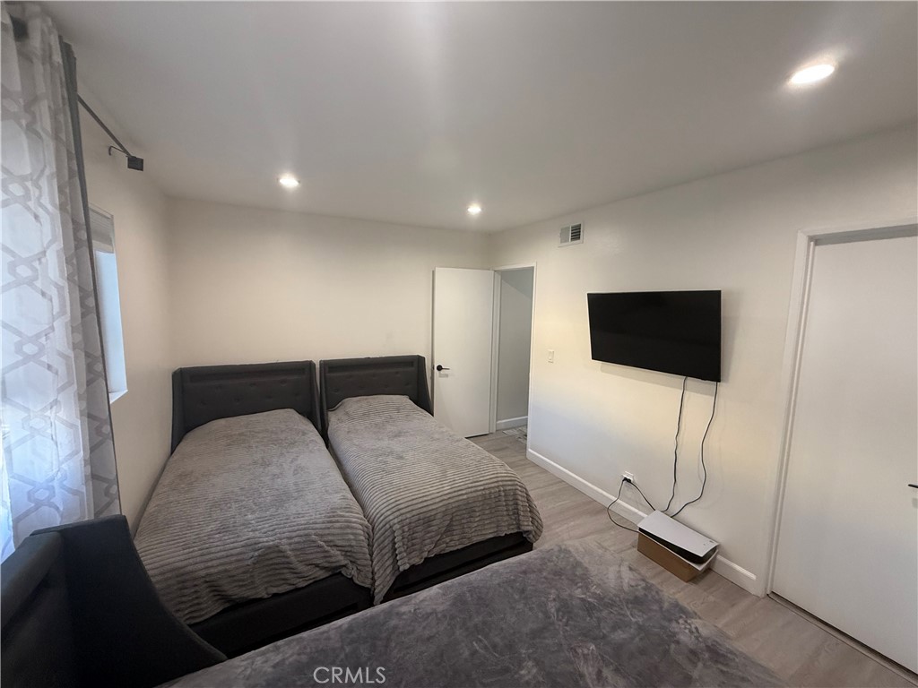 9702 Vía Roma Burbank, CA 91504 - Photo 10 of 19 a bedroom with a bed and a flat screen tv
