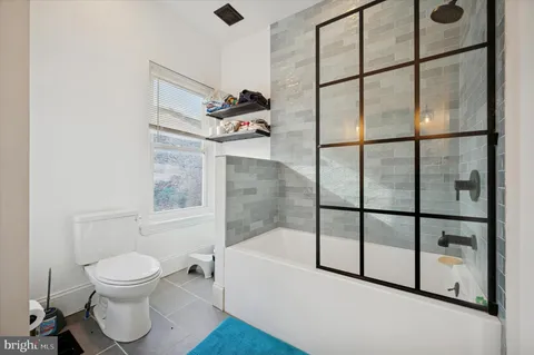 a bathroom with a toilet and a shower
