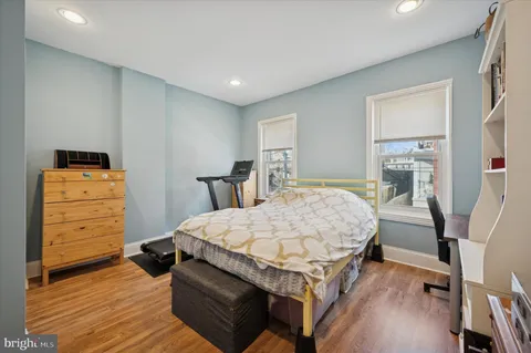 a bed room with a bed and wooden floor