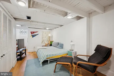 a bedroom with a bed and a chair