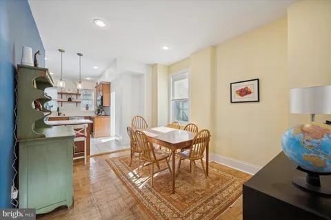 a dining room with furniture and wooden floor