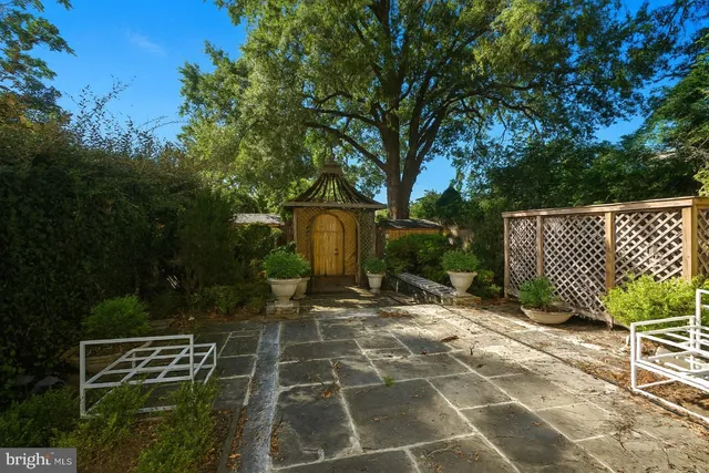 a view of a wooden door with a bench
