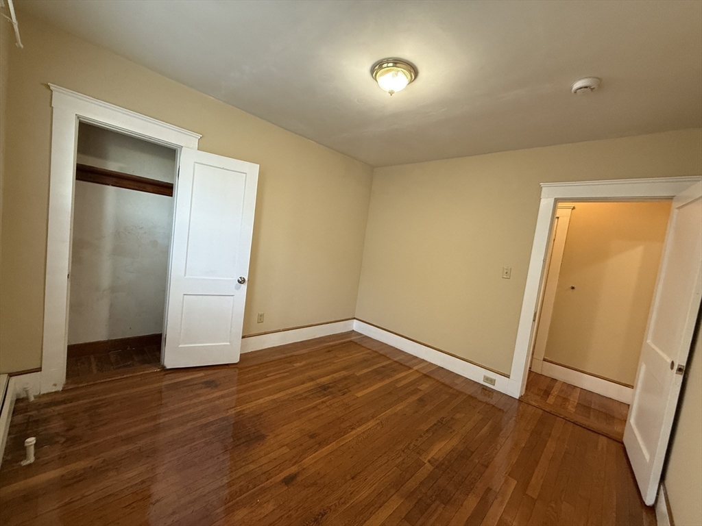 17 Wales Street, Unit 3 Boston, MA 02124 - Photo 12 of 17 an empty room with wooden floor and entrance