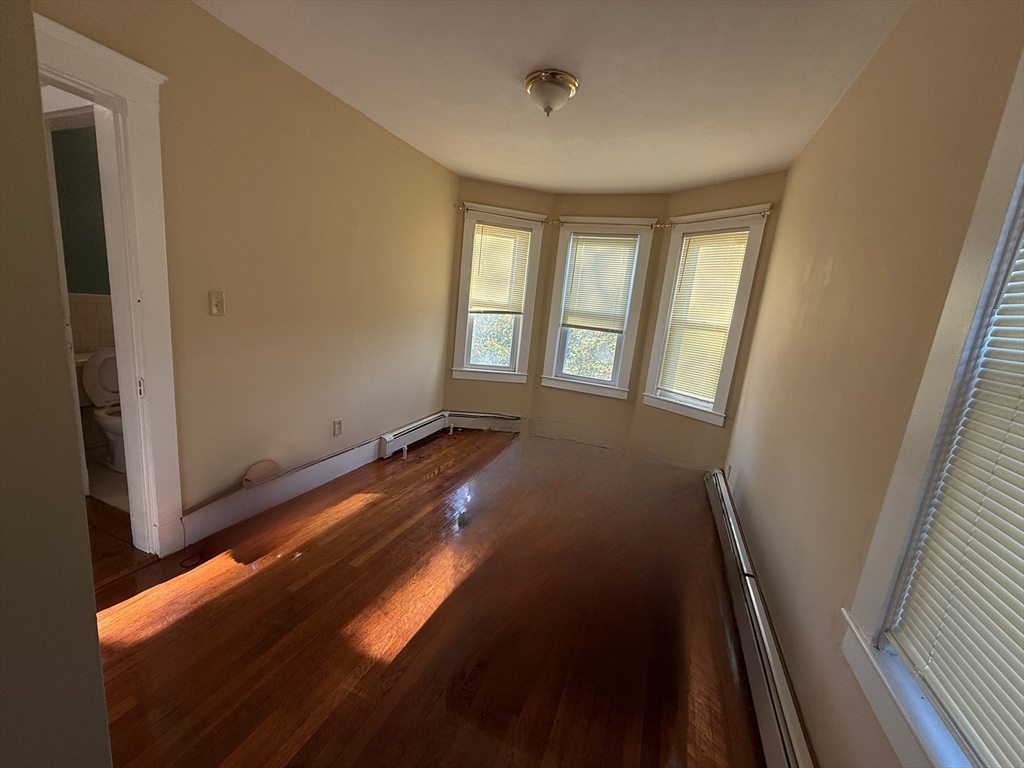 17 Wales Street, Unit 3 Boston, MA 02124 - Photo 17 of 17 a view of wooden floor and windows in a room
