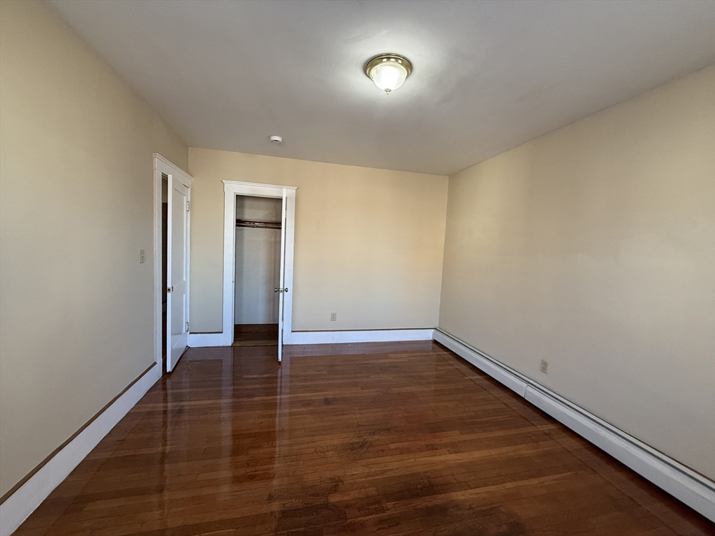 17 Wales Street, Unit 3 Boston, MA 02124 - Photo 5 of 17 a view of an empty room with wooden floor and a window