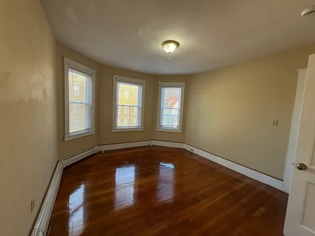 a view of a room with wooden floor