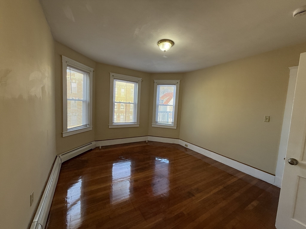 17 Wales Street, Unit 3 Boston, MA 02124 - Photo 6 of 17 a view of empty room with wooden floor and fan