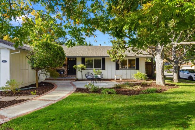 a view of a patio with table and chairs and potted plants
