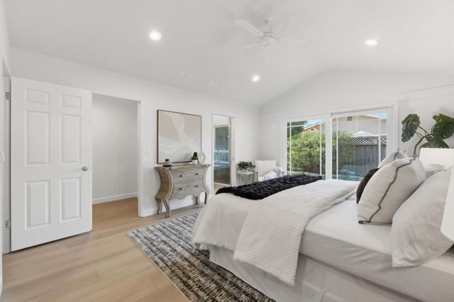 a tree in front of a white house