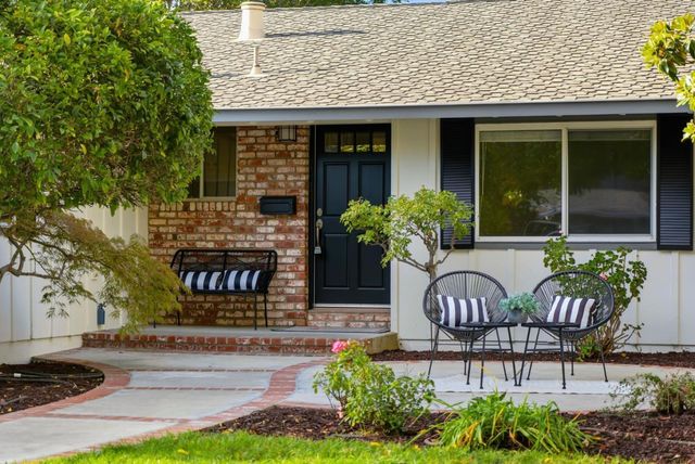 a large kitchen with stainless steel appliances granite countertop a lot of counter space and a sink